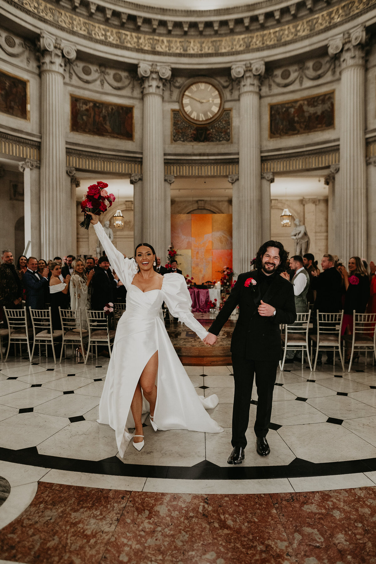 A bride and groom exit their wedding at City Hall in Dublin.