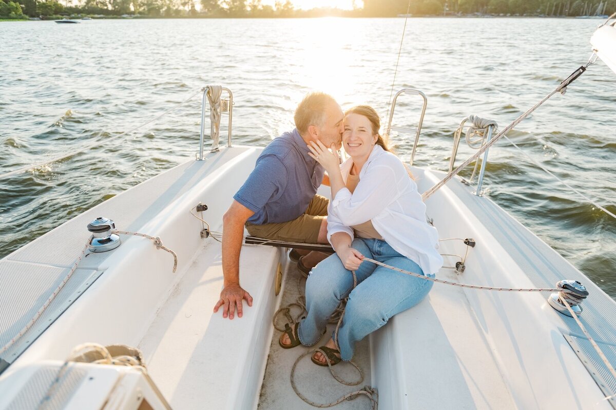 a man kissing his fiance on a boat