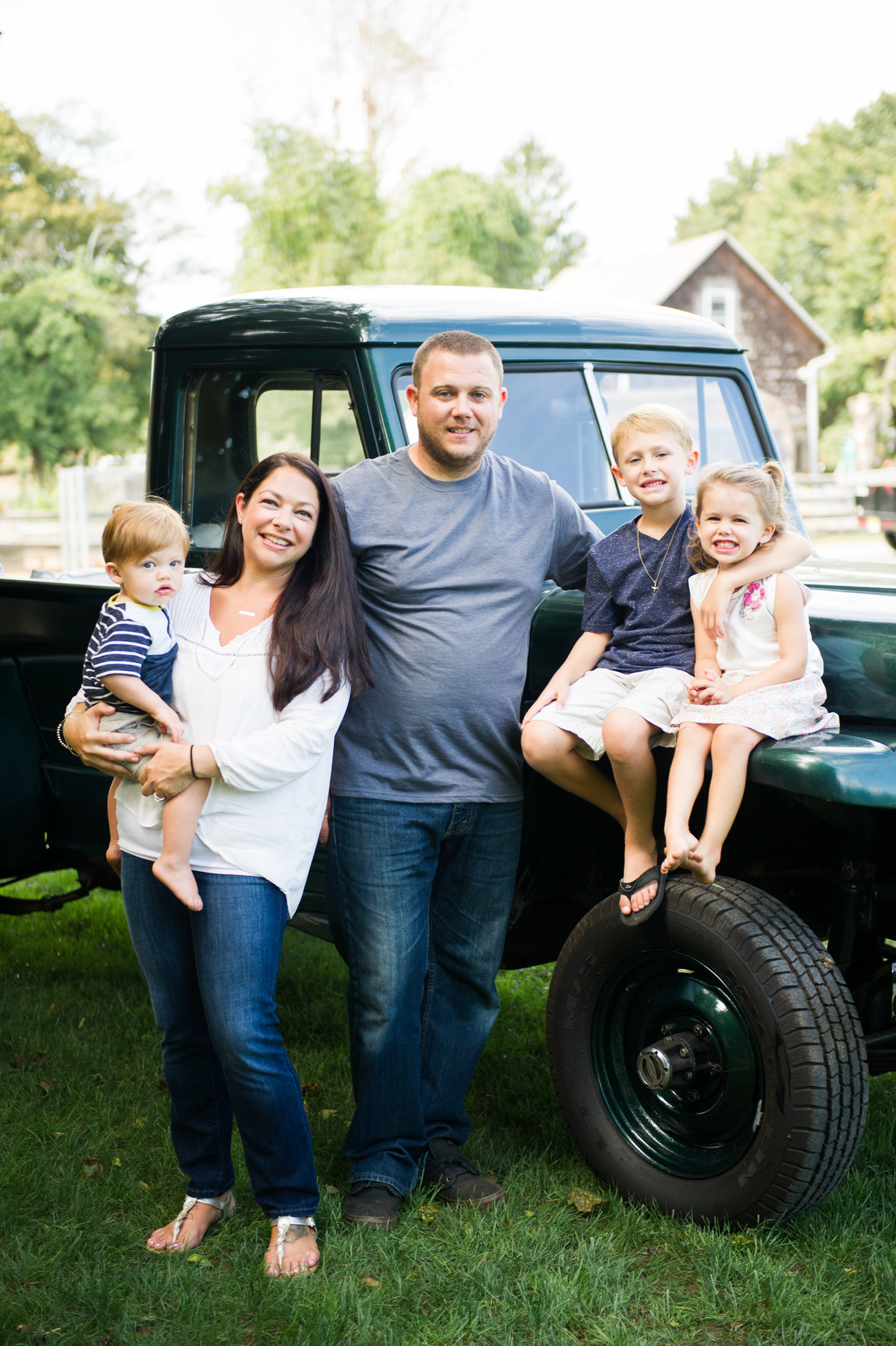 family pose with green truck