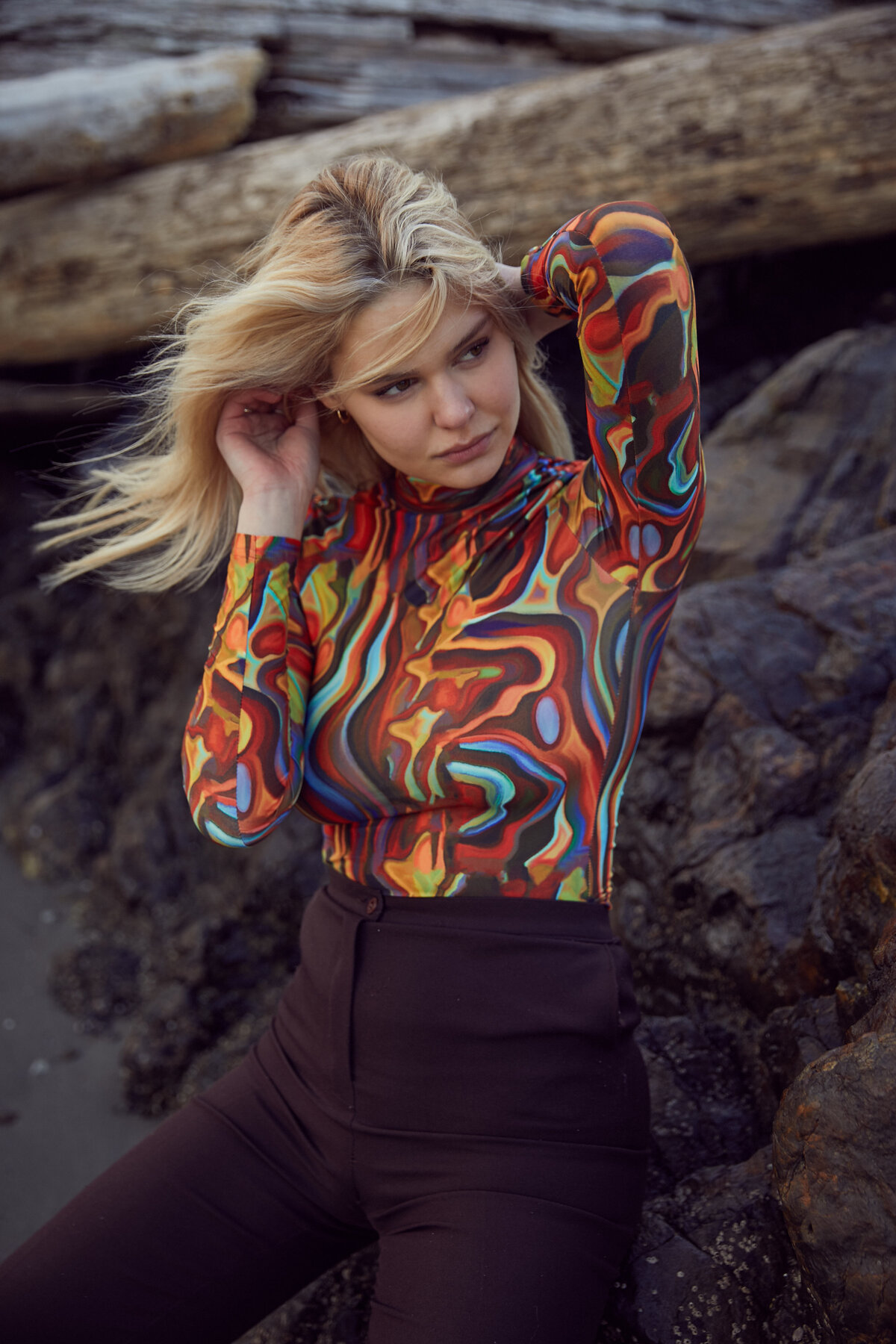 Picture of girl sitting on the rocks in a 70's shirt