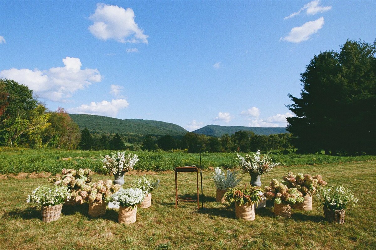 ceremony-altar-floral-baskets-field-wedding