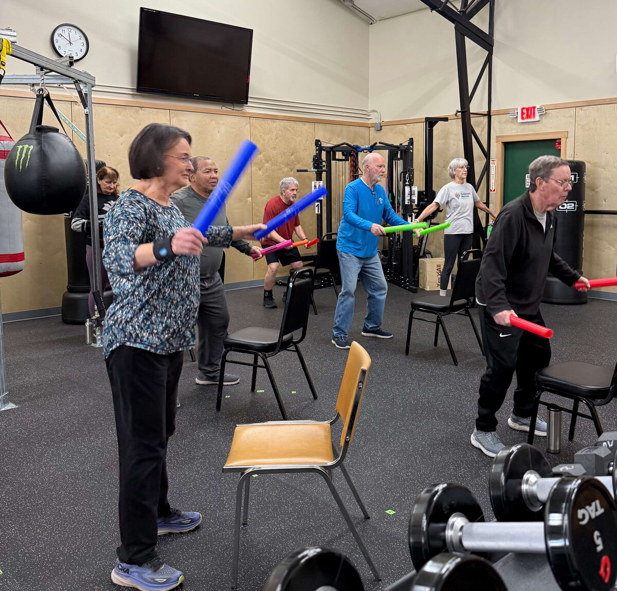 A group of parkinsons warriors follow Lori's instruction in a exercise and boxing program.