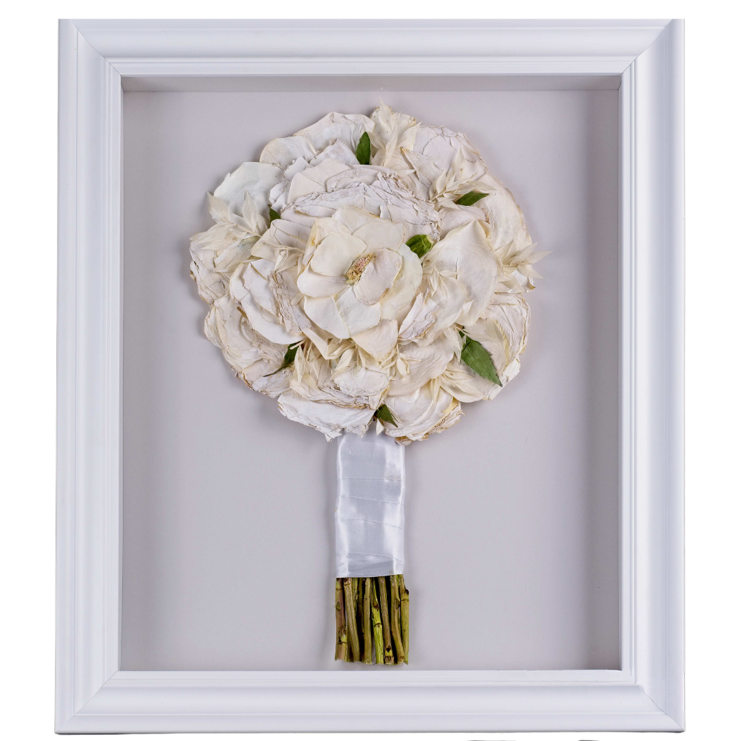 Pressed wedding bouquet in wooden frame.