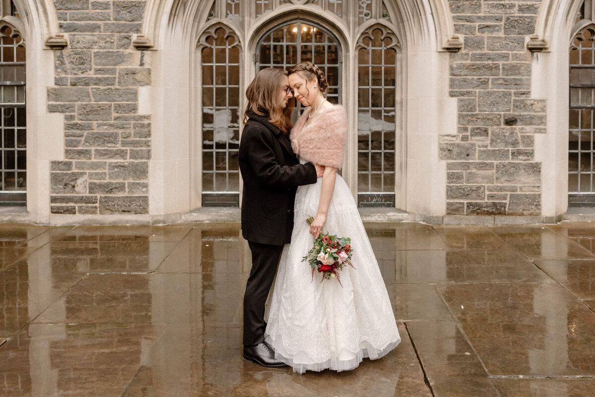 toronto ontario hart house university of toronto bride and groom embrace in courtyard in february