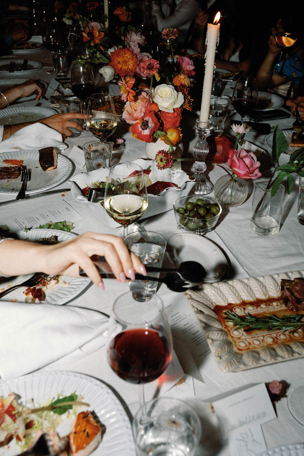 NYC palma dinner party wedding reception with hand reaching for food