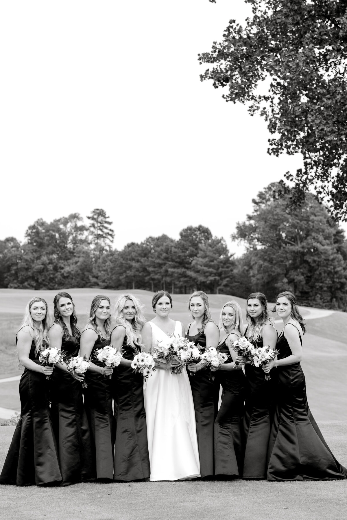 bride posing with her bridesmaids
