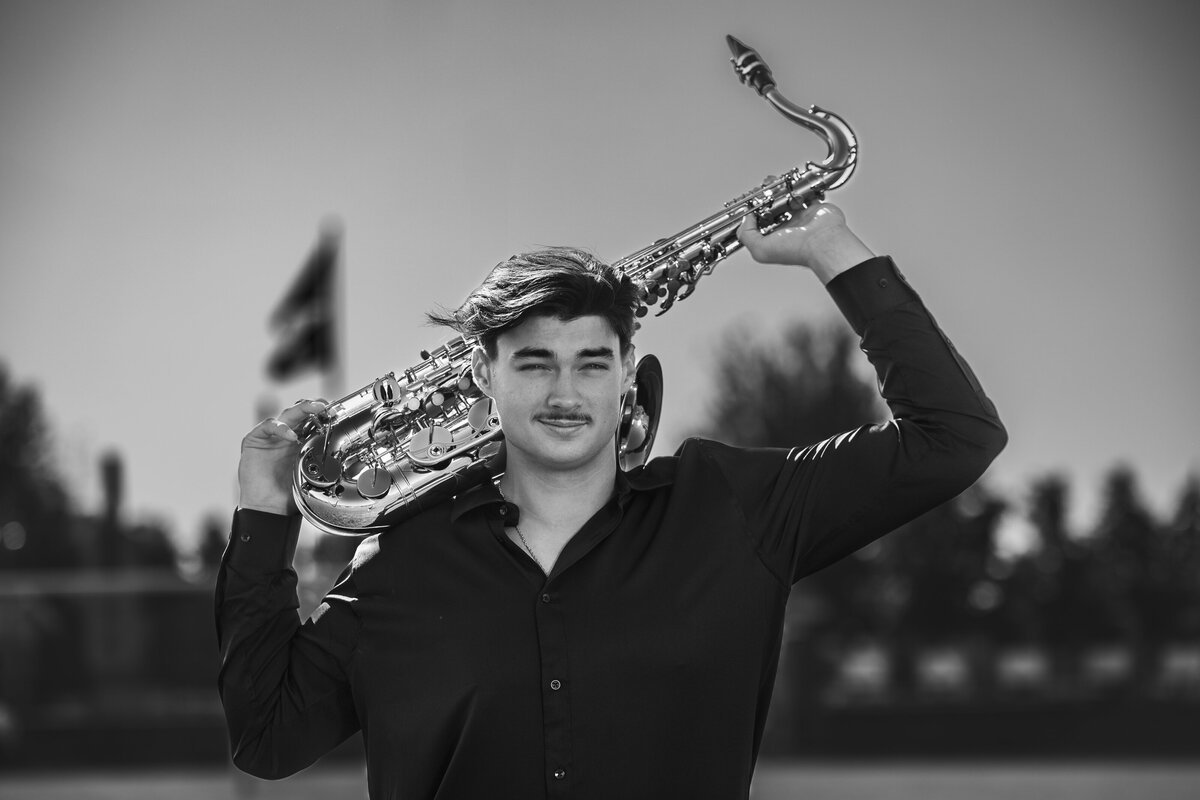 high-school-saxophonist-holding-saxophone-on-shoulders