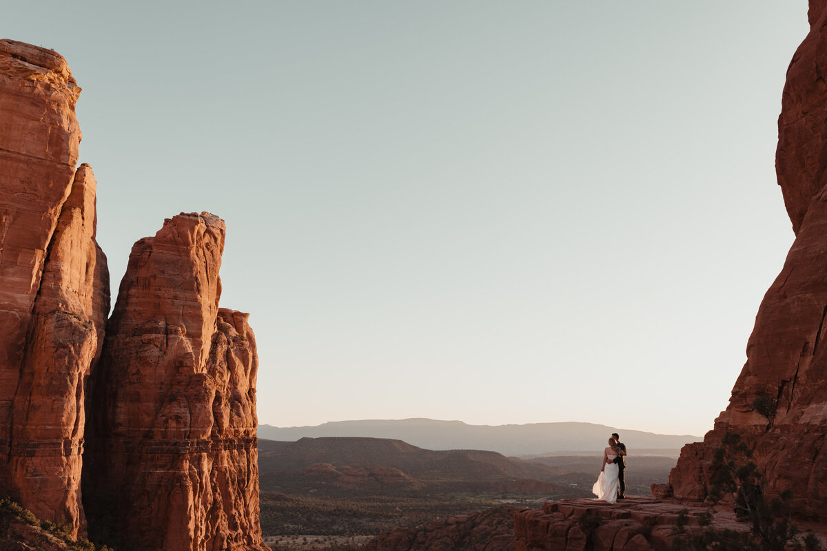 Elopement couple at Cathedral Rock Sedona during golden hour. Red rock wedding portraits Sedona Photos taken by Kollar Photography