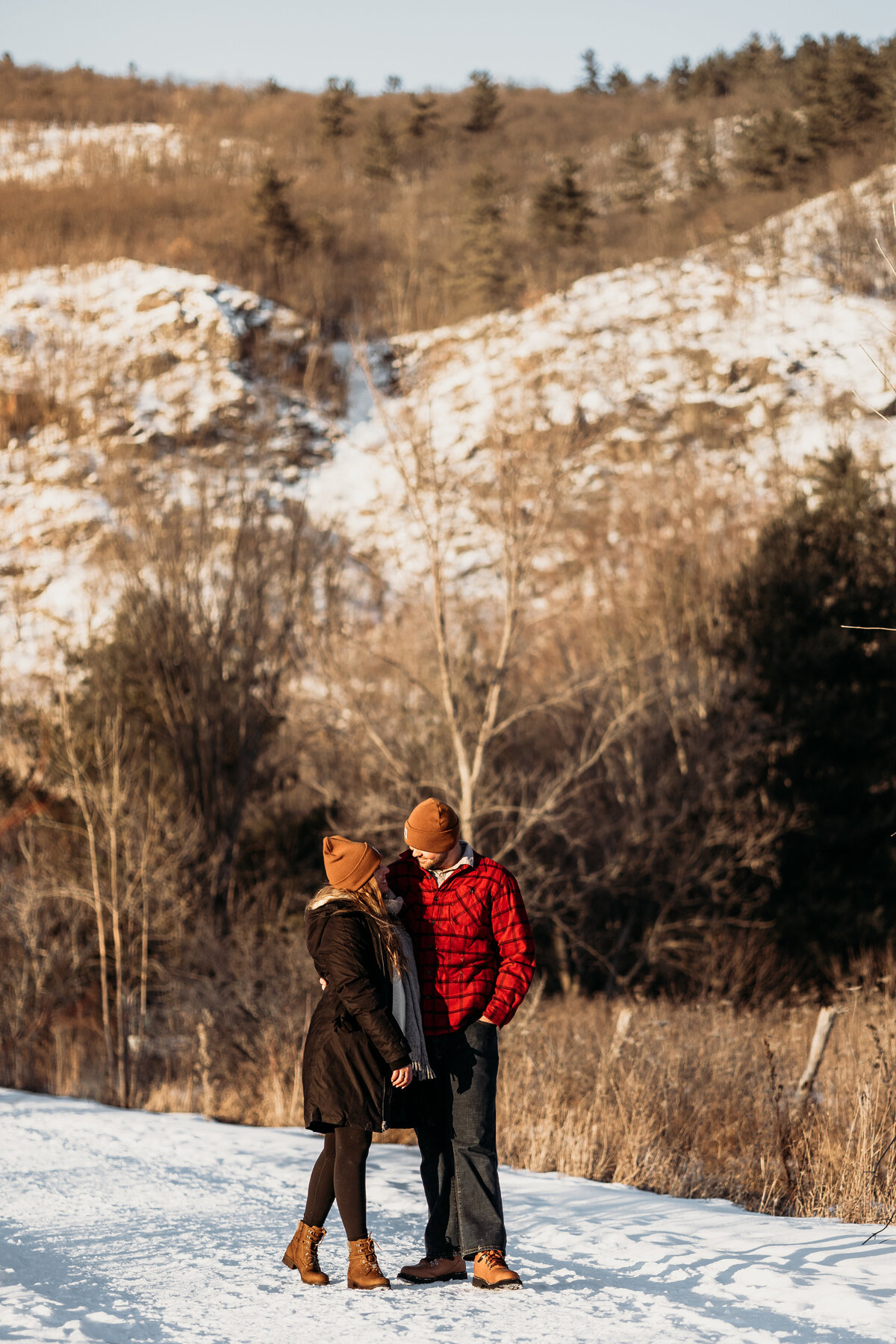 Couple standing together with the Gatineau hills behind them