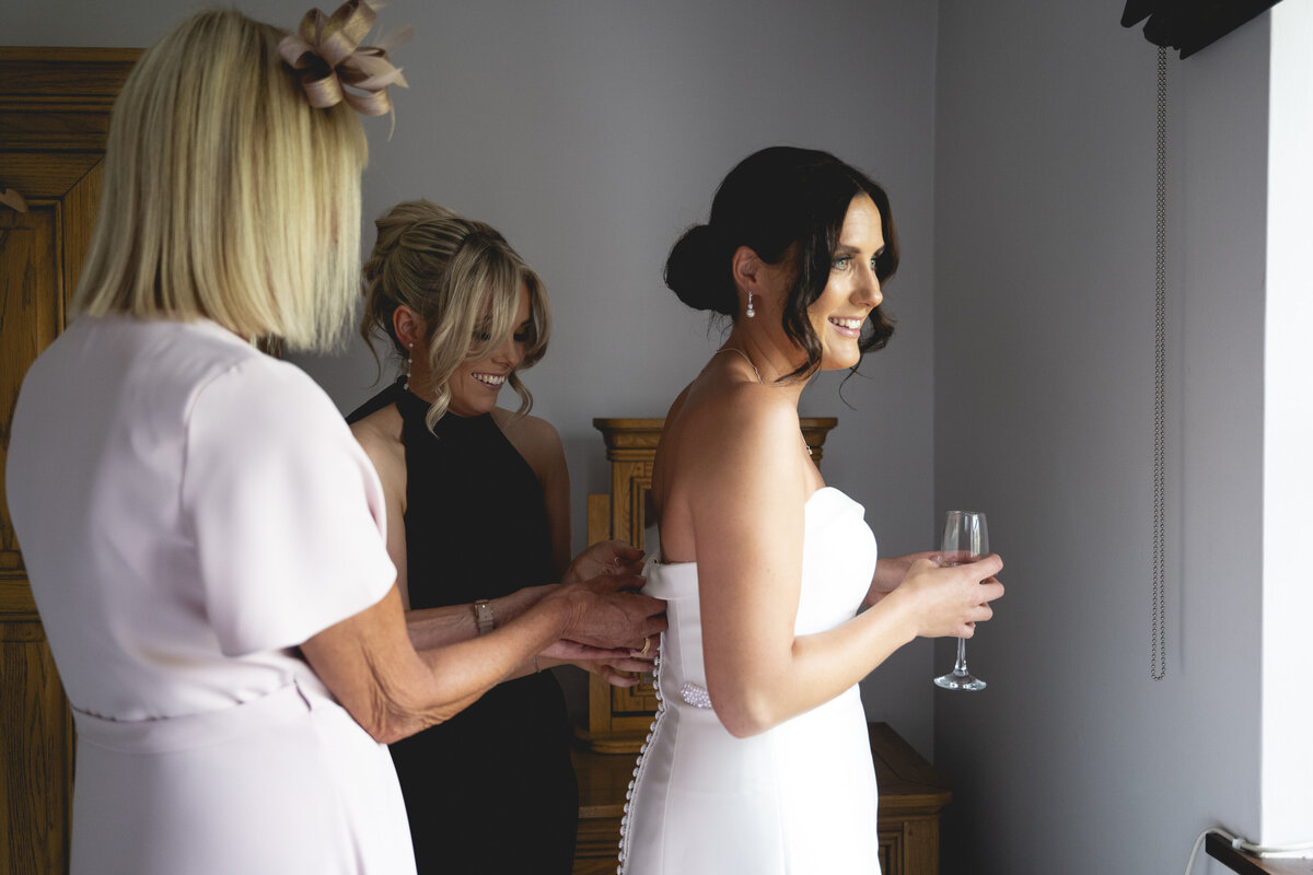Amy having her dress fastened up