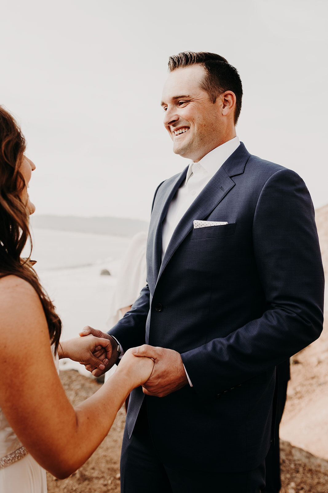 a bride and groom holding hands as they exchange vowes