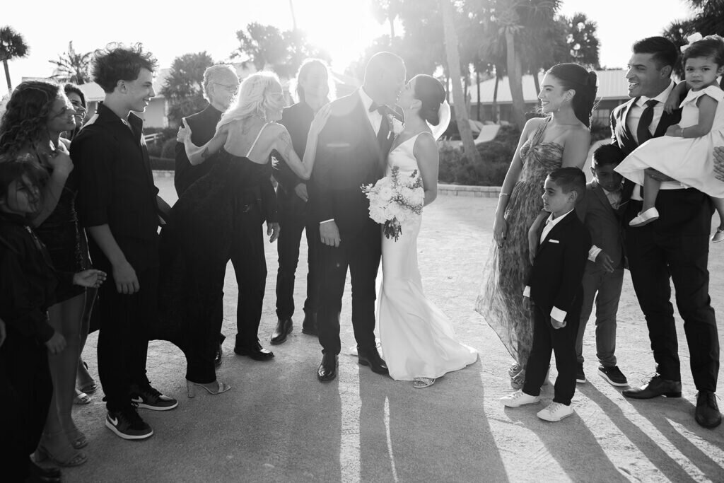 A joyful post-ceremony celebration as the bride and groom walk hand in hand with their wedding party, filled with laughter and excitement. Destination wedding photography by Claudia Amalia Photography in the Florida Keys.