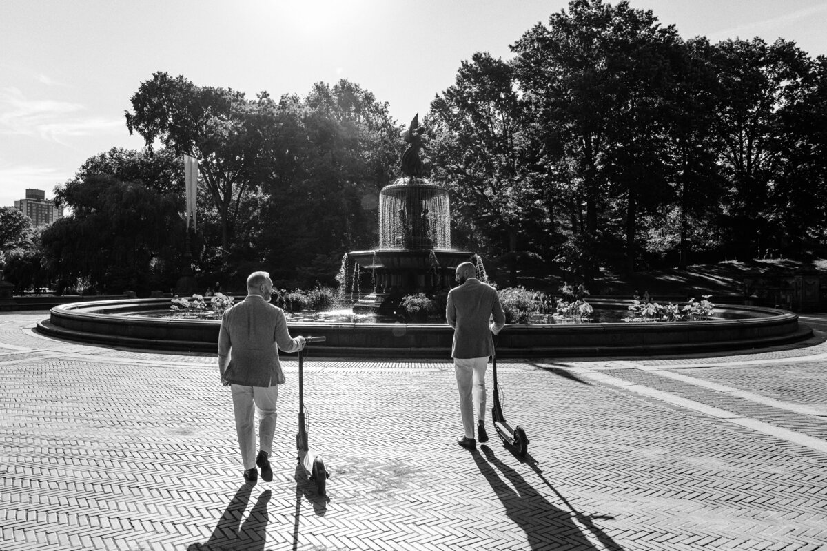 A couple ride matching scooters at the Bethesda Terrace