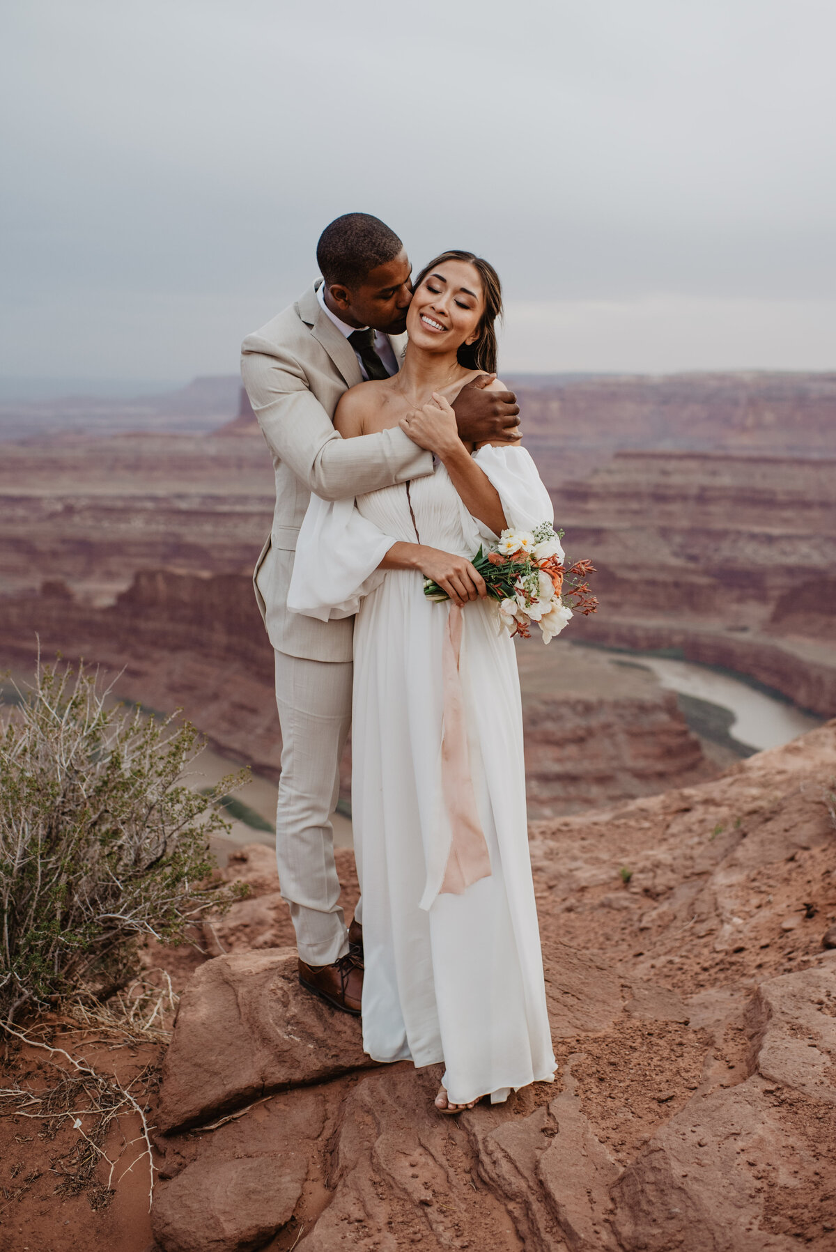 Utah Elopement Photographer captures groom kissing bride's forehead