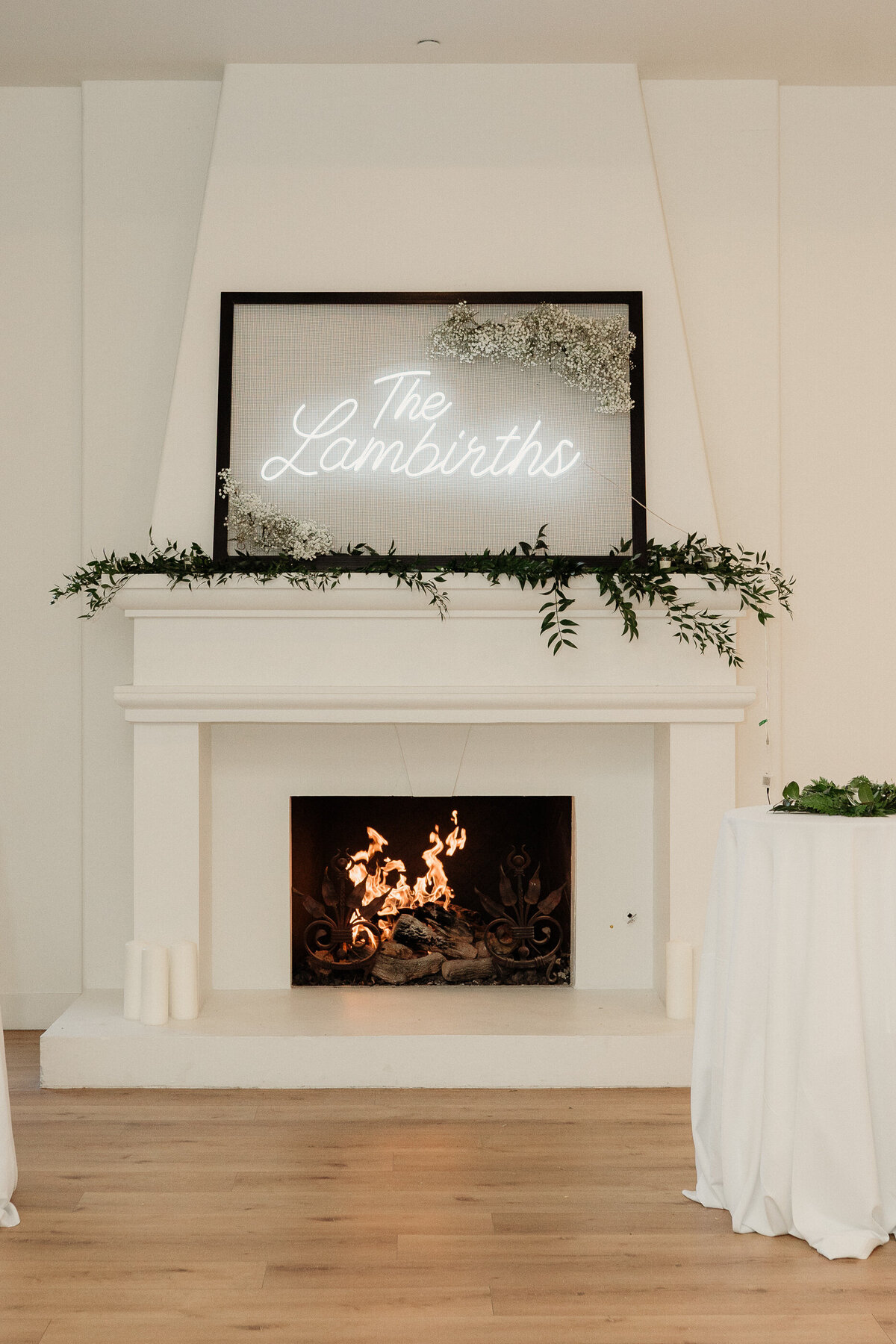 neon wedding sign in a empty frame hangs on top of a fireplace at spanish hills country club wedding captured by los angeles wedding photographer magnolia west photography