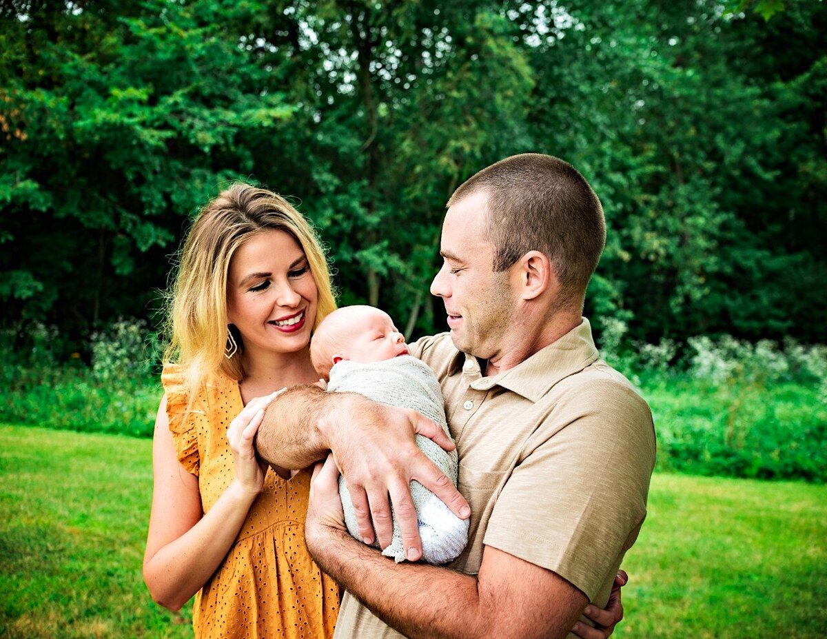 parents looking at newborn boy