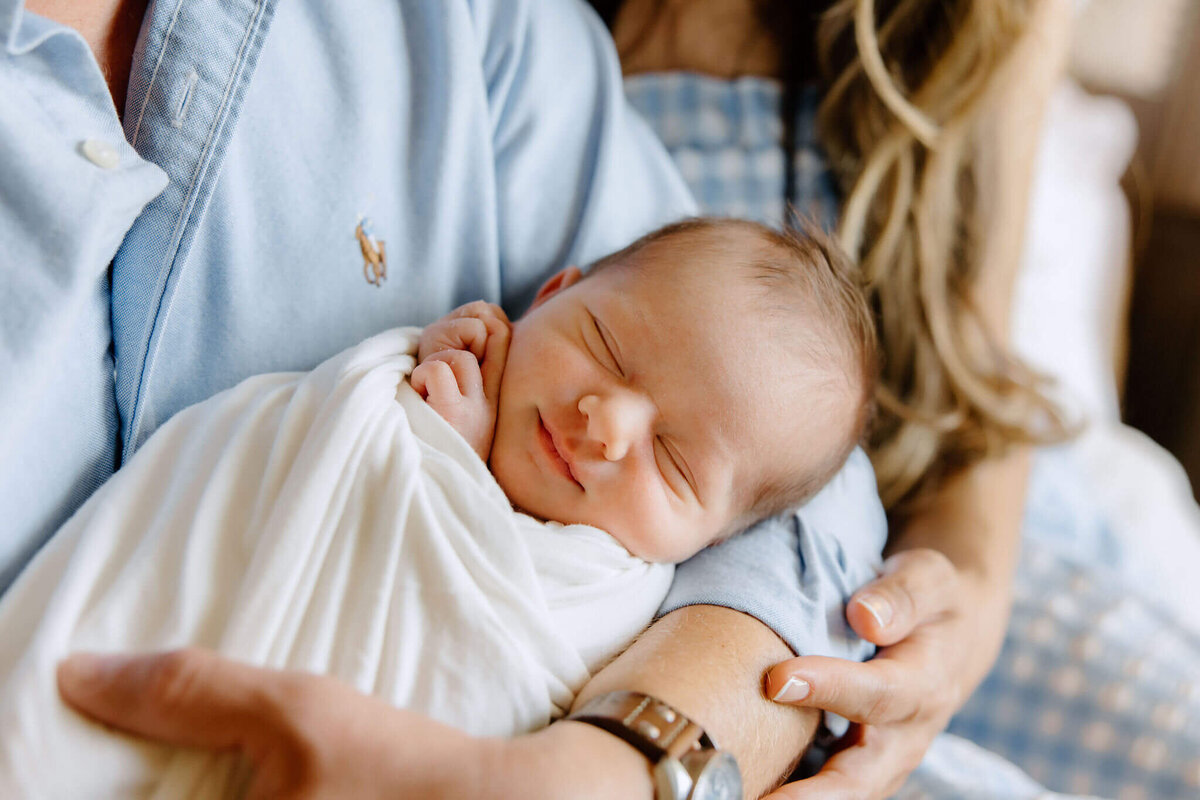candid newborn photo of baby boy in parents arms