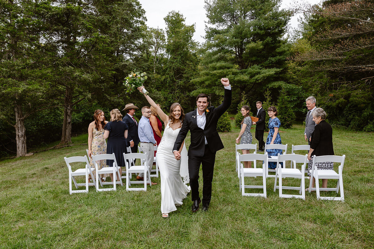 A couple walking back up the aisle after their elopement