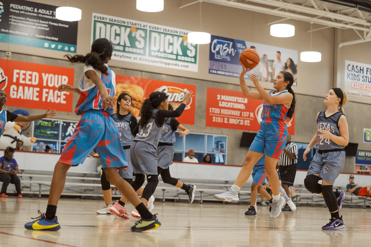 Full Circle Basketball TX athlete taking a jump shot during a youth basketball game in Fort Worth.