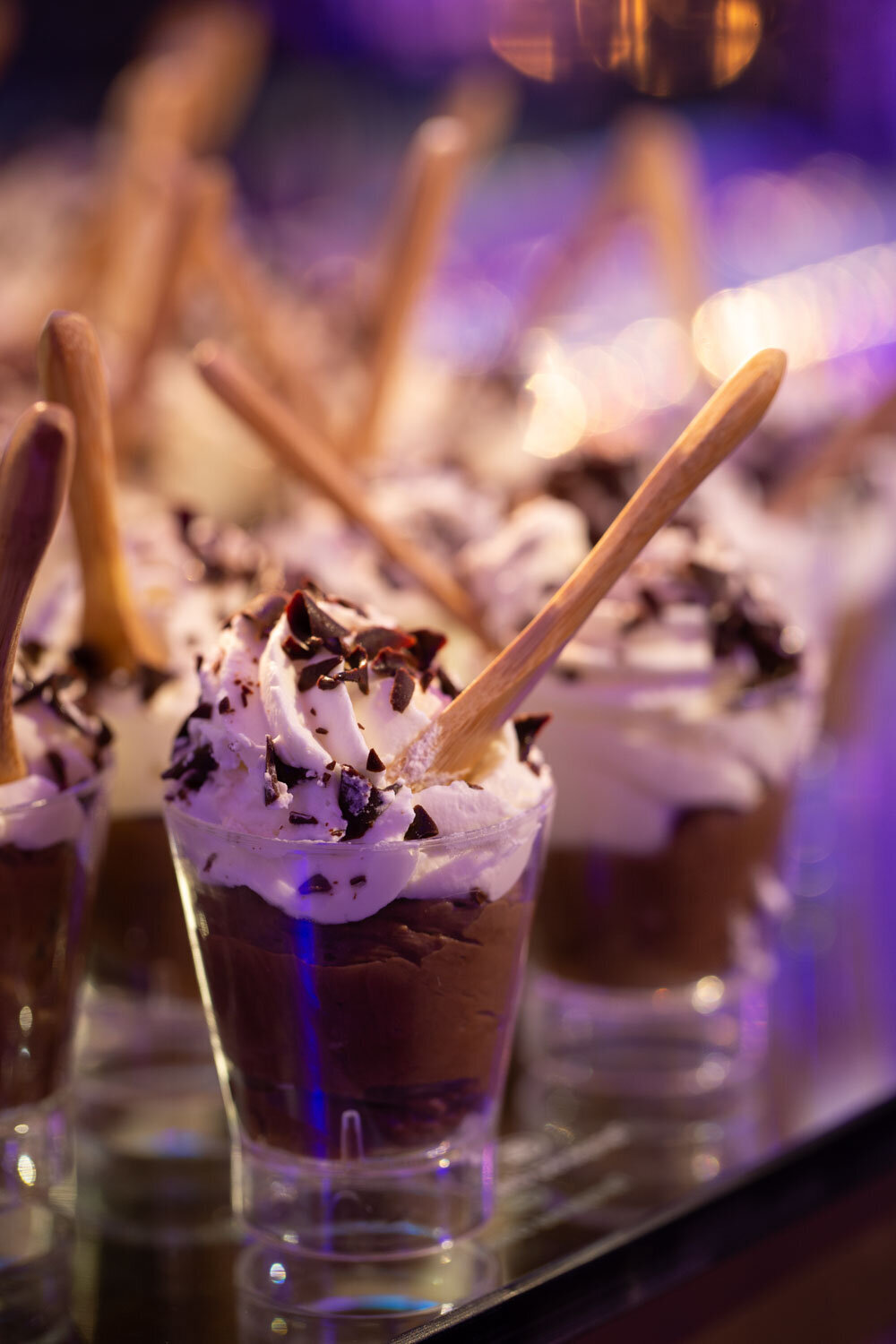 Chocolate mousse desserts with whipped cream and spoons