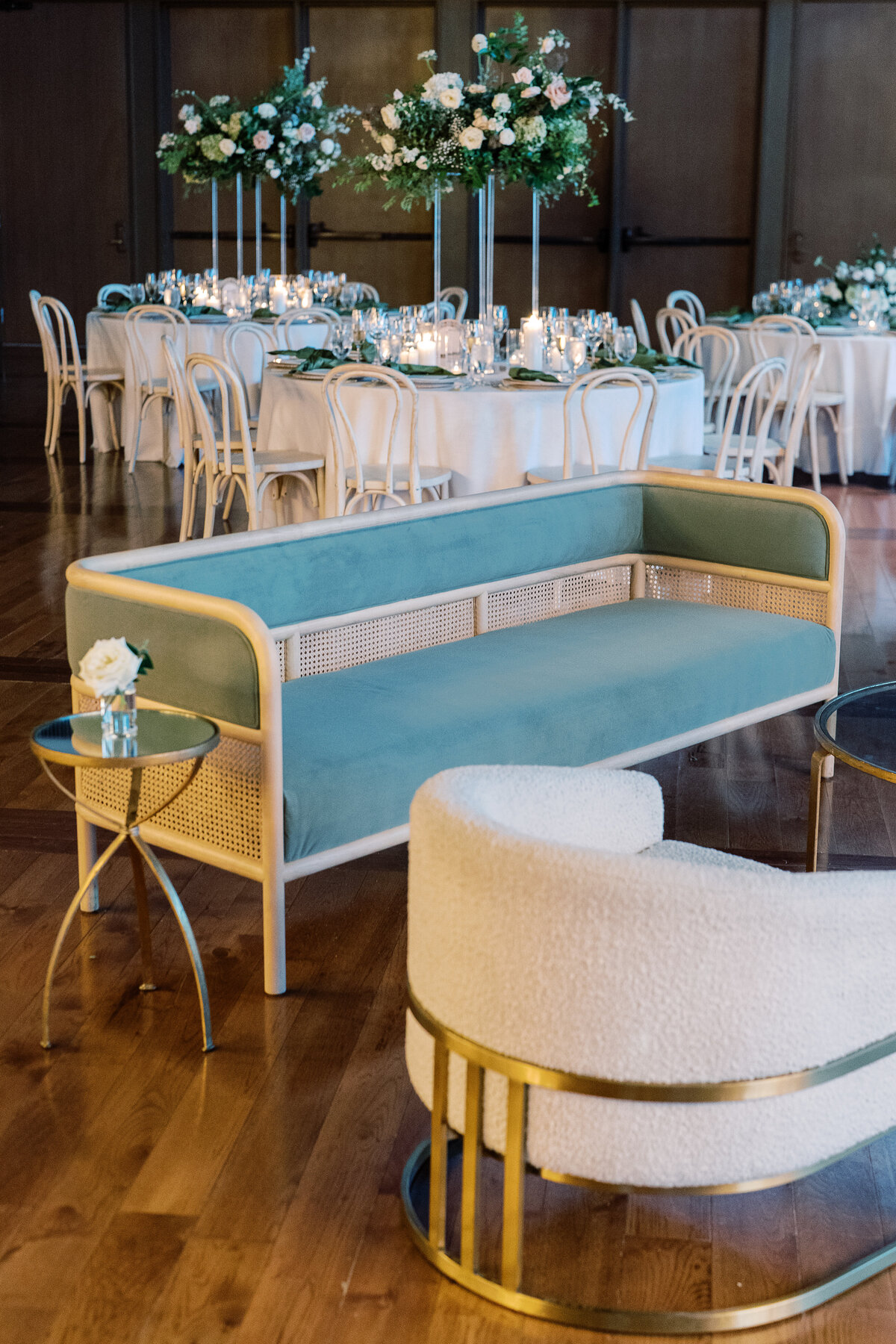 Classic bud vases accent the lounge area of this garden-inspired summer wedding reception. Timeless white and green floral design for downtown Nashville wedding. Design by Rosemary & Finch Floral Design.