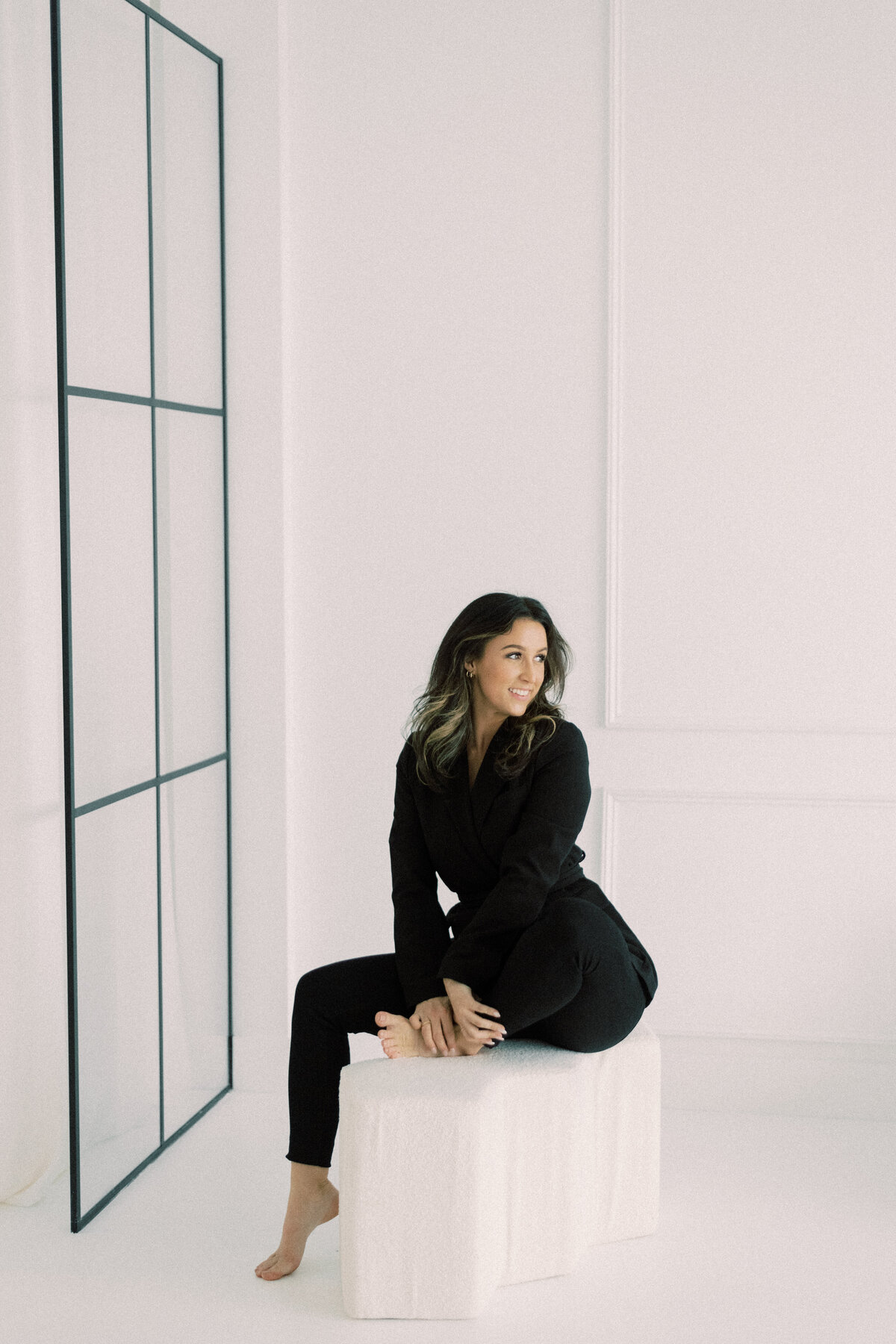 Elegant portrait in black outfit in a minimalist Scandinavian studio