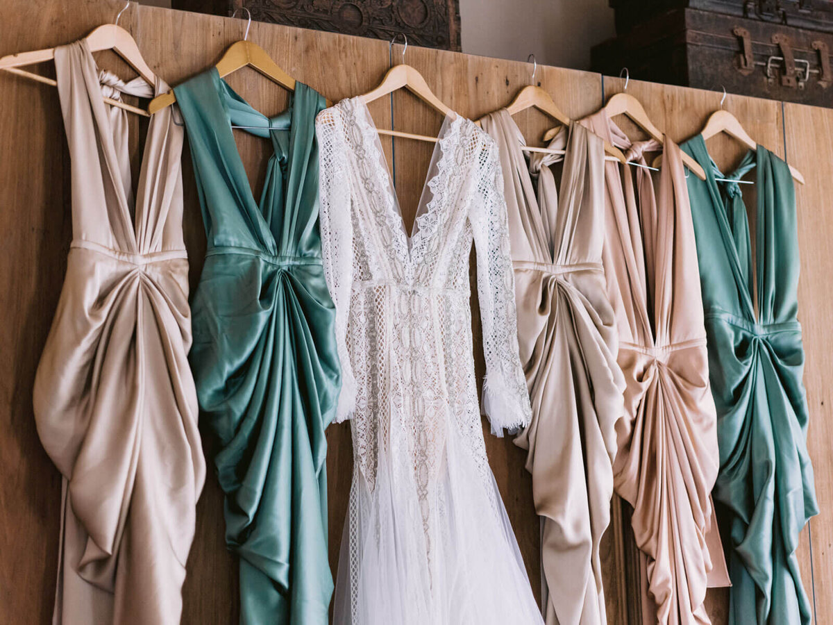 The bride and bridesmaids' dresses are hung together inside the room in Khayangan Estate, Indonesia. Image by Jenny Fu Studio