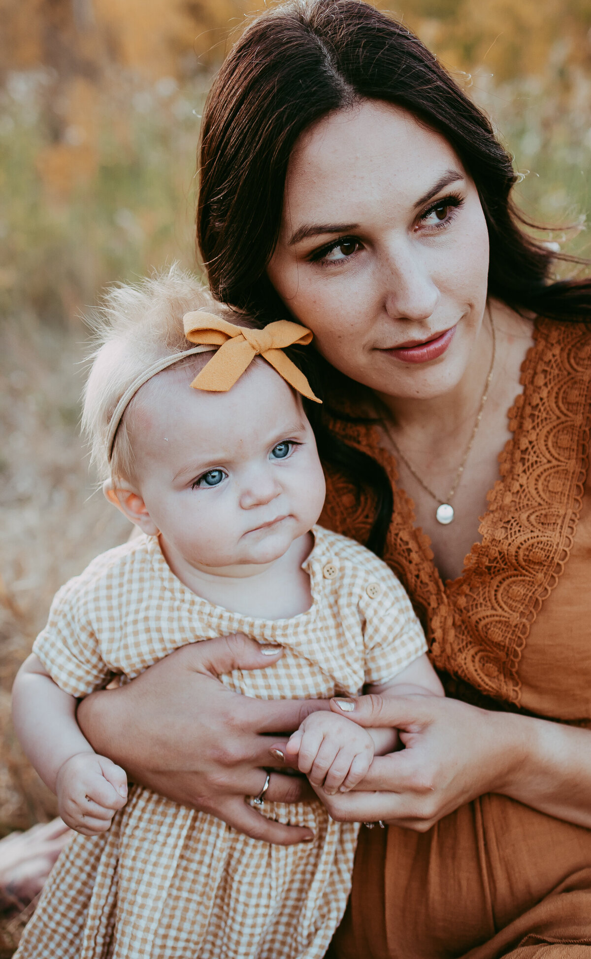 mom holding baby daughter