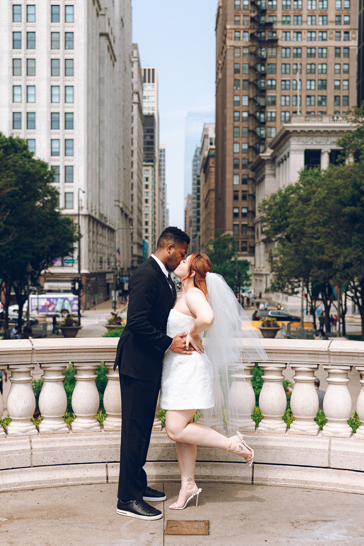 A couple poses in downtown Chicago during their elopement