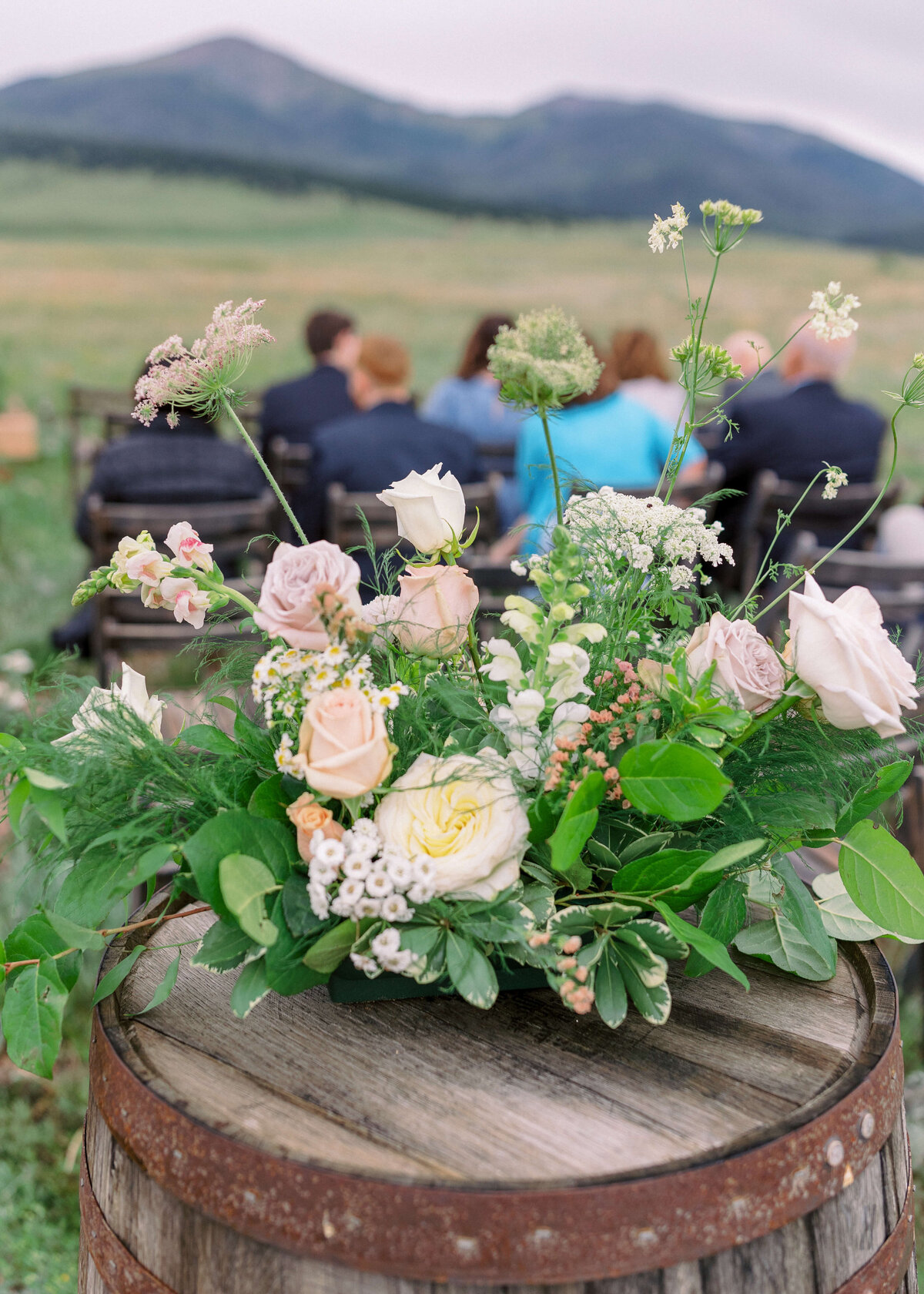 Beautiful pastel florals welcomed guests to the ceremony space of an outdoor wedding