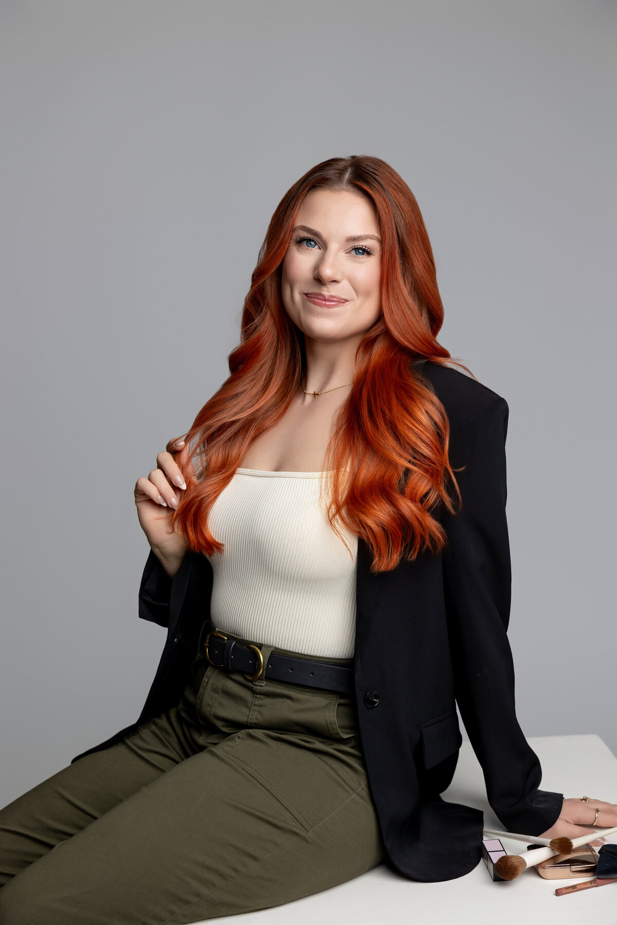 Confident branding portrait of red-haired woman smiling in a studio setting. Photograph by Yucaipa branding photographer Kaitlyn Dawn Photography.Confident branding portrait of red-haired woman smiling in a studio setting. Photograph by Yucaipa branding photographer Kaitlyn Dawn Photography.