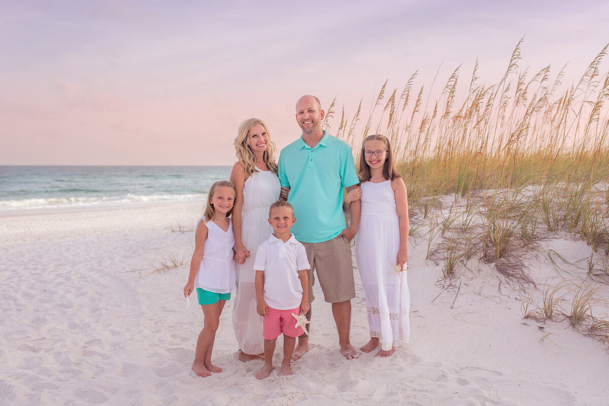 family-of-five-posing-by-the-dunes-on-navarre-beach