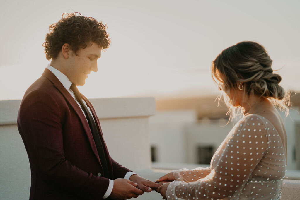Bride and groom exchanging rings at their Zion rooftop elopement