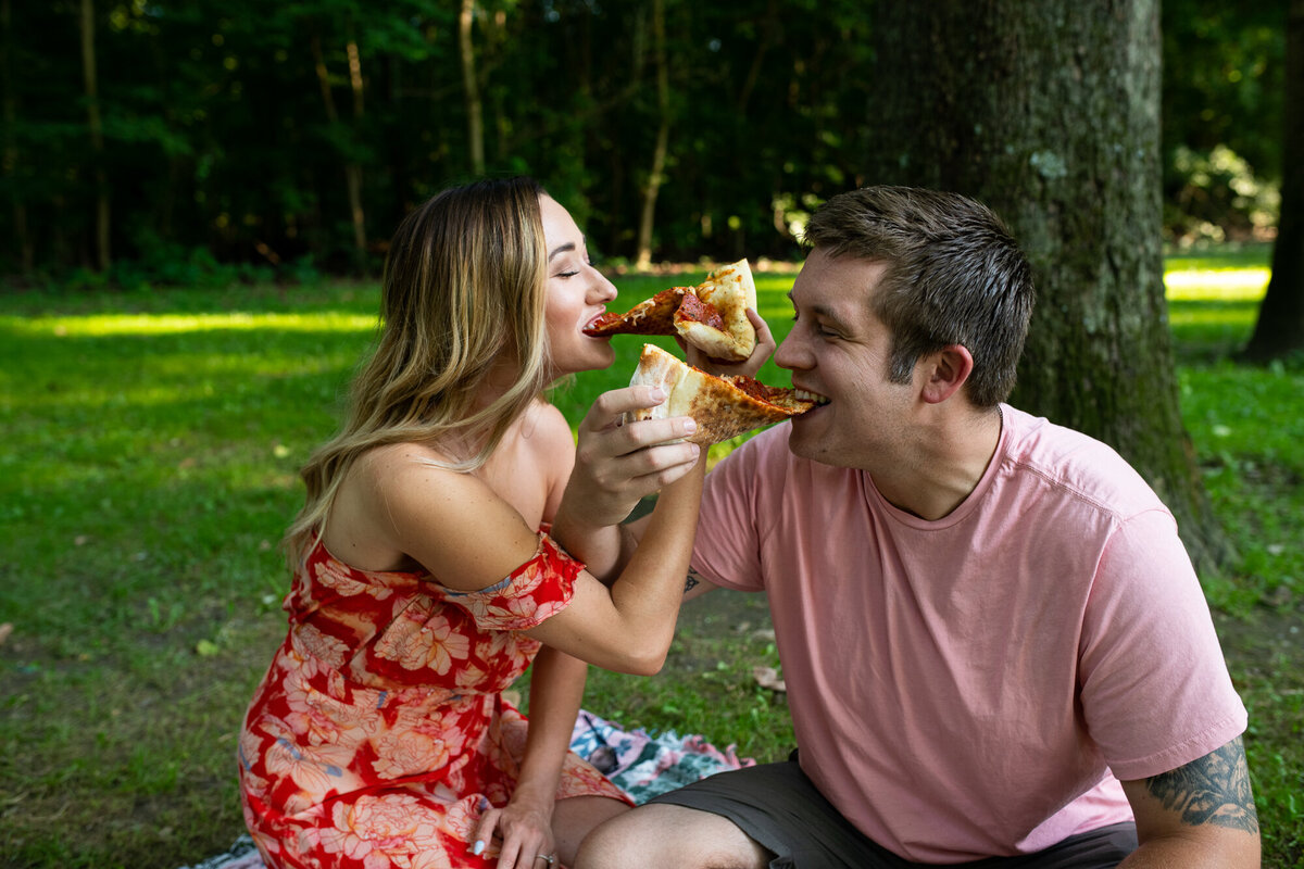 Couple shares a pizza during their engagement session