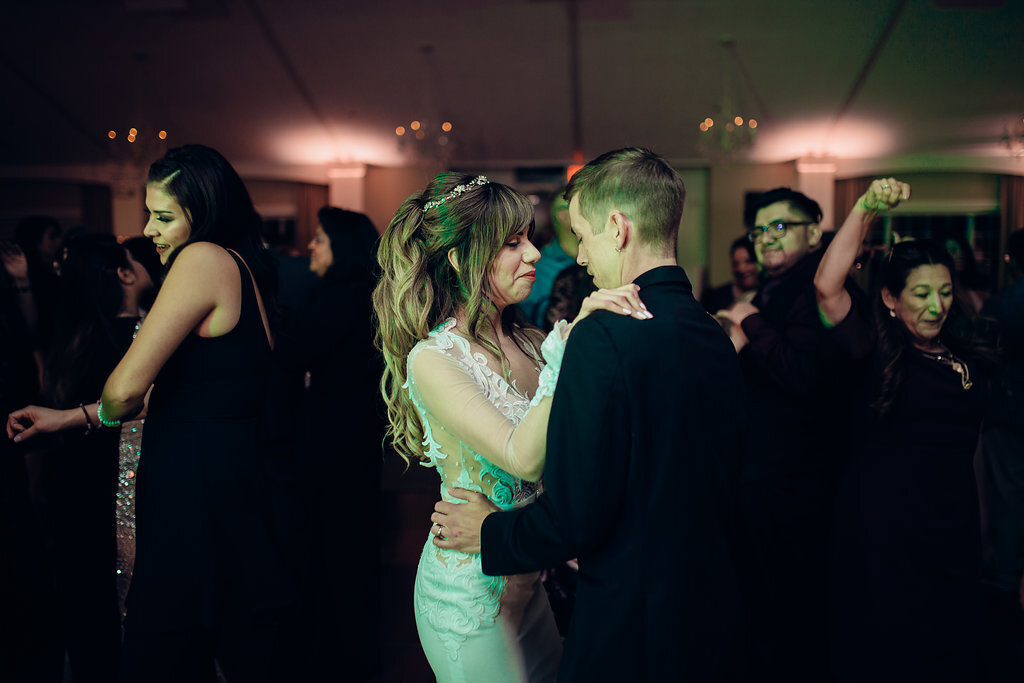Wedding Photograph Of Bride And Groom Staring At Each Other While Dancing In The Middle Of The Crowd Los Angeles