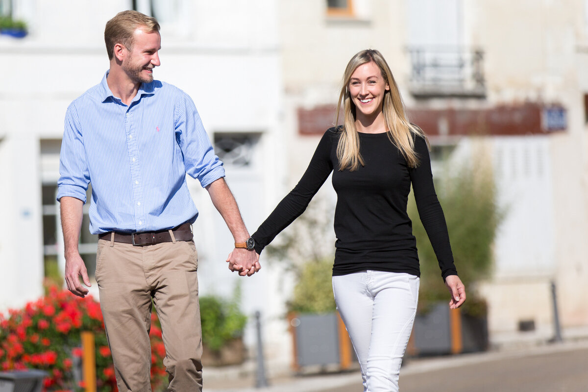 couple holding hands on walk