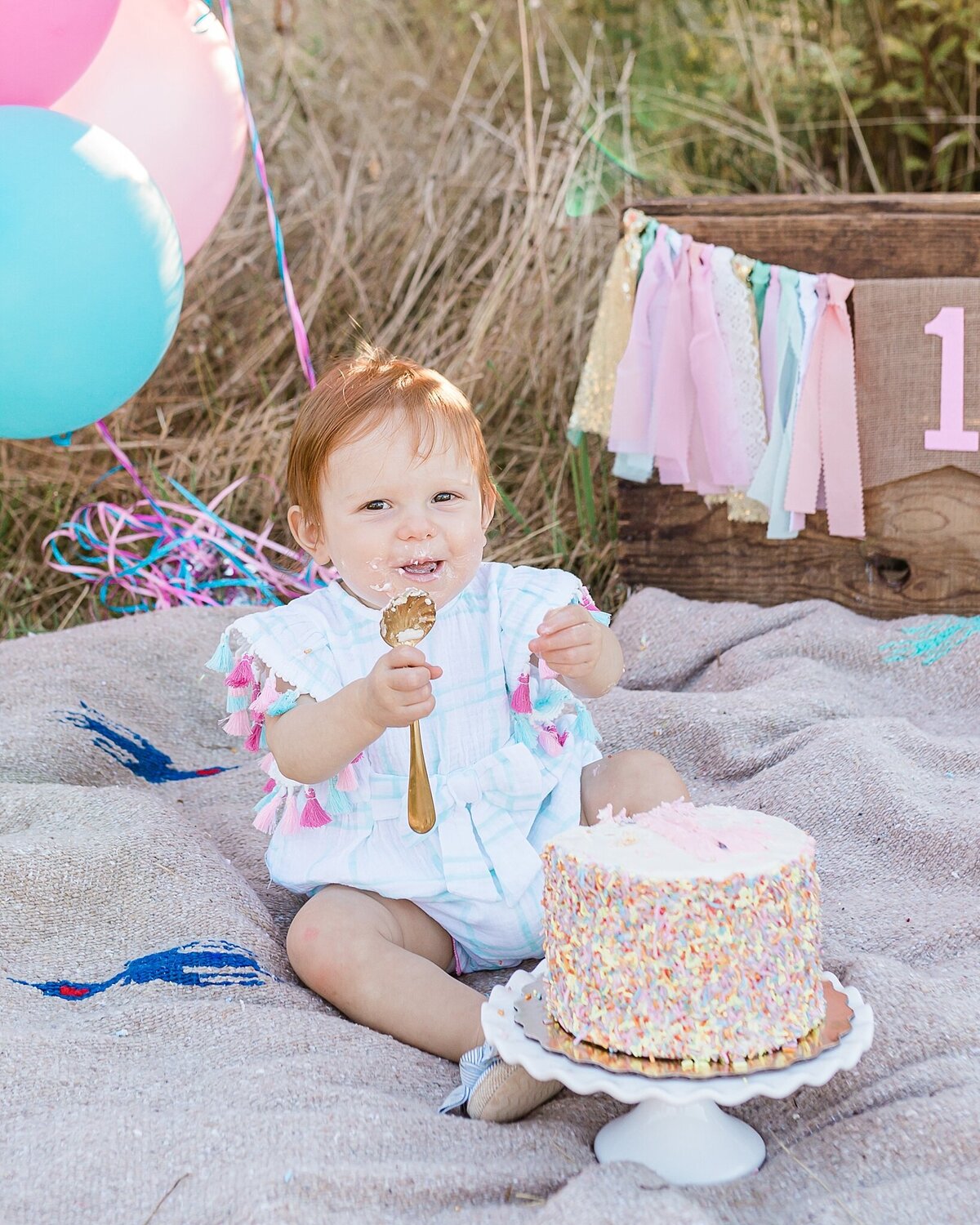 baby girl eating sprinkle cake for one year pictures