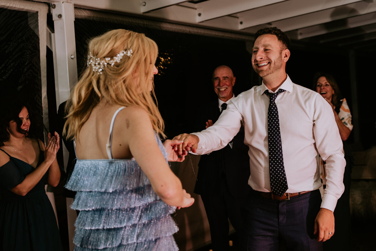 Bride and groom dancing during wedding reception in Italy