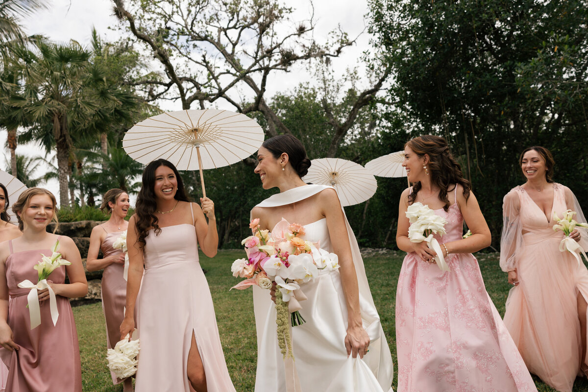 bride leaning on car laughing by naples florida wedding photographer