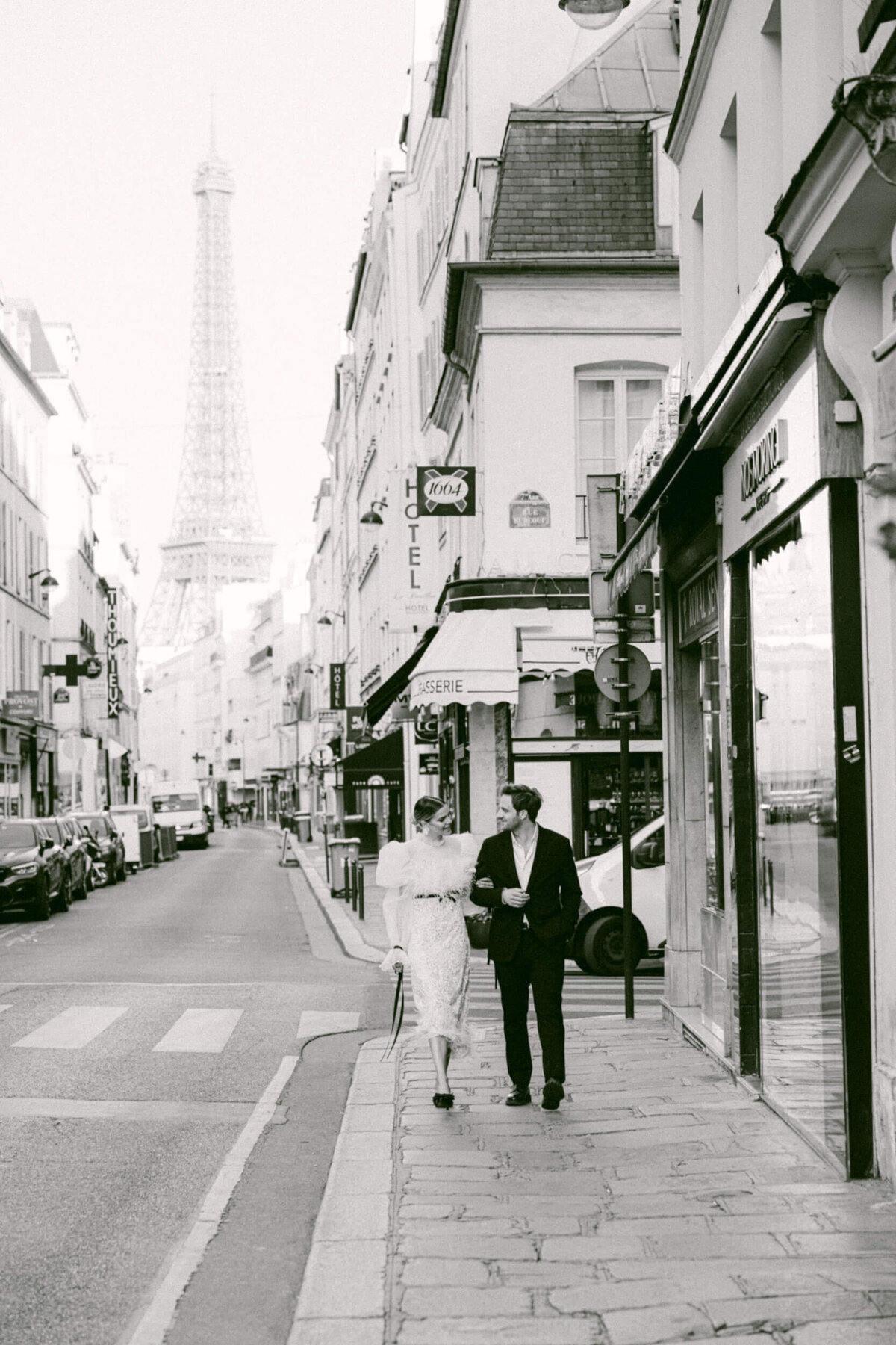 A wedding photo of a bride in her white dress in the streets of Paris in France.