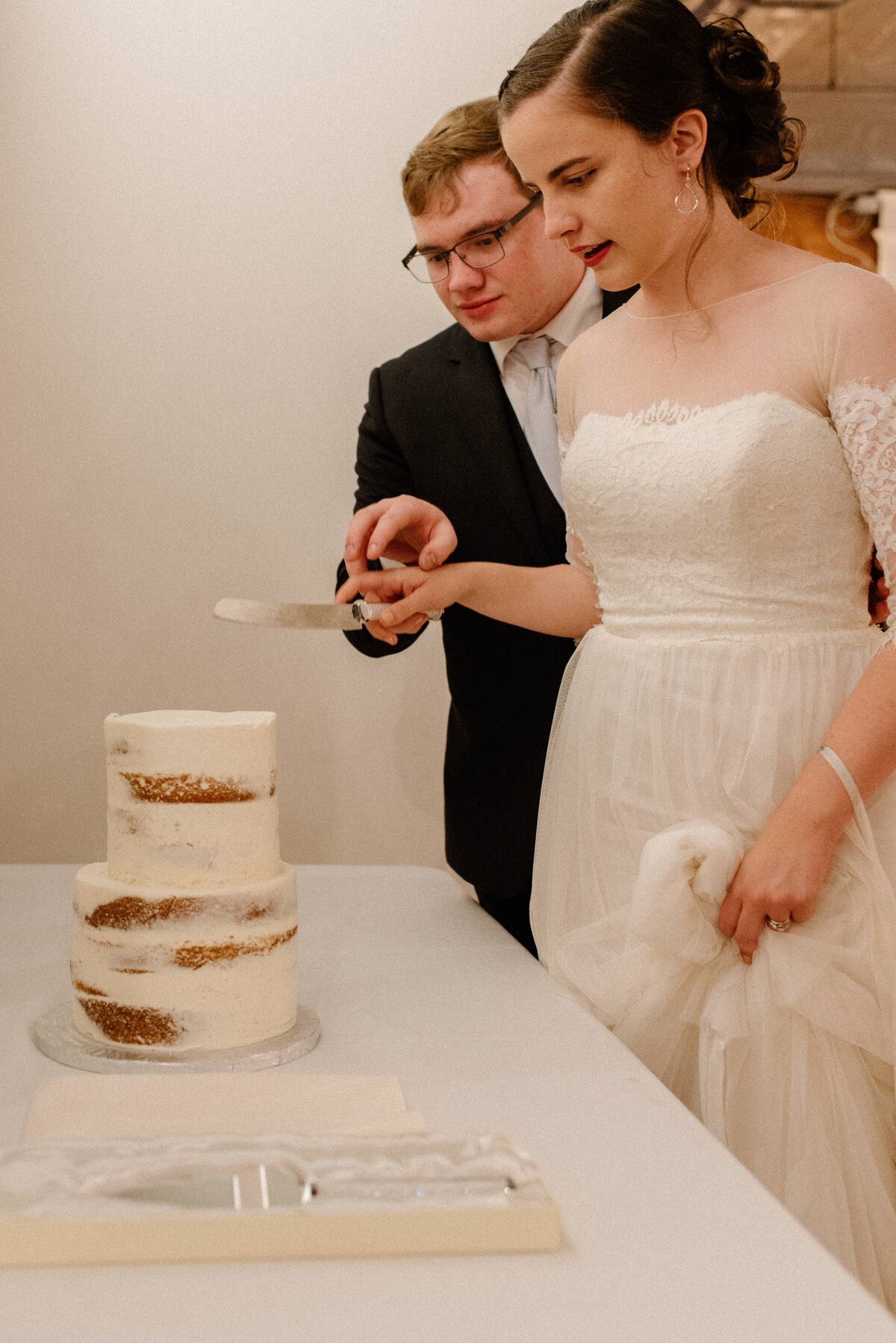 hamilton ontario spice factory wedding bride and groom cut cake together