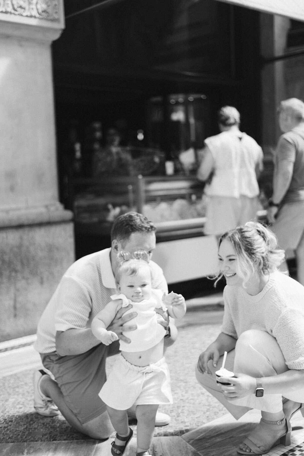 Father embracing daughter outside an italy milano, a moment of stillness and connection
