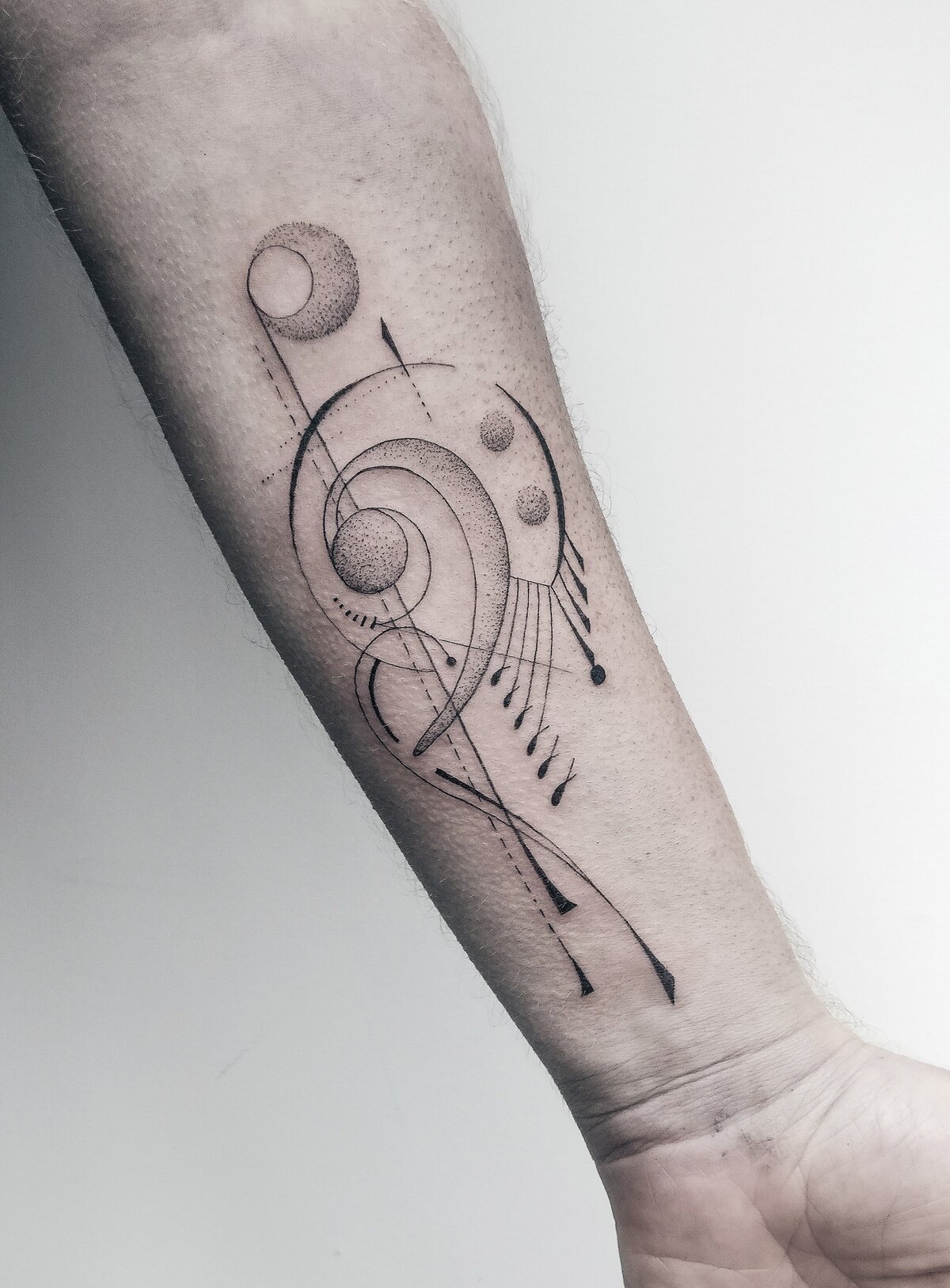 music tattoo, bass clef tattoo, abstract tattoo, geometric tattoo