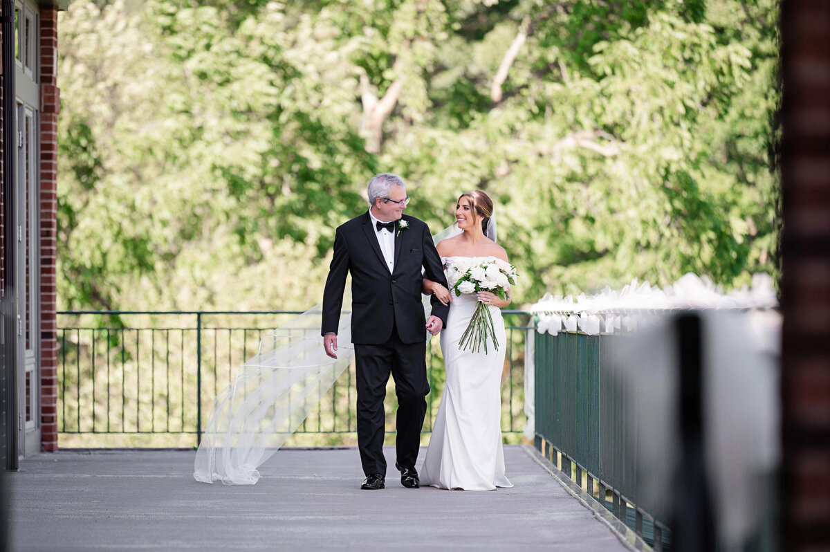 bride and dad candid walking down aisle at southpointe golf club