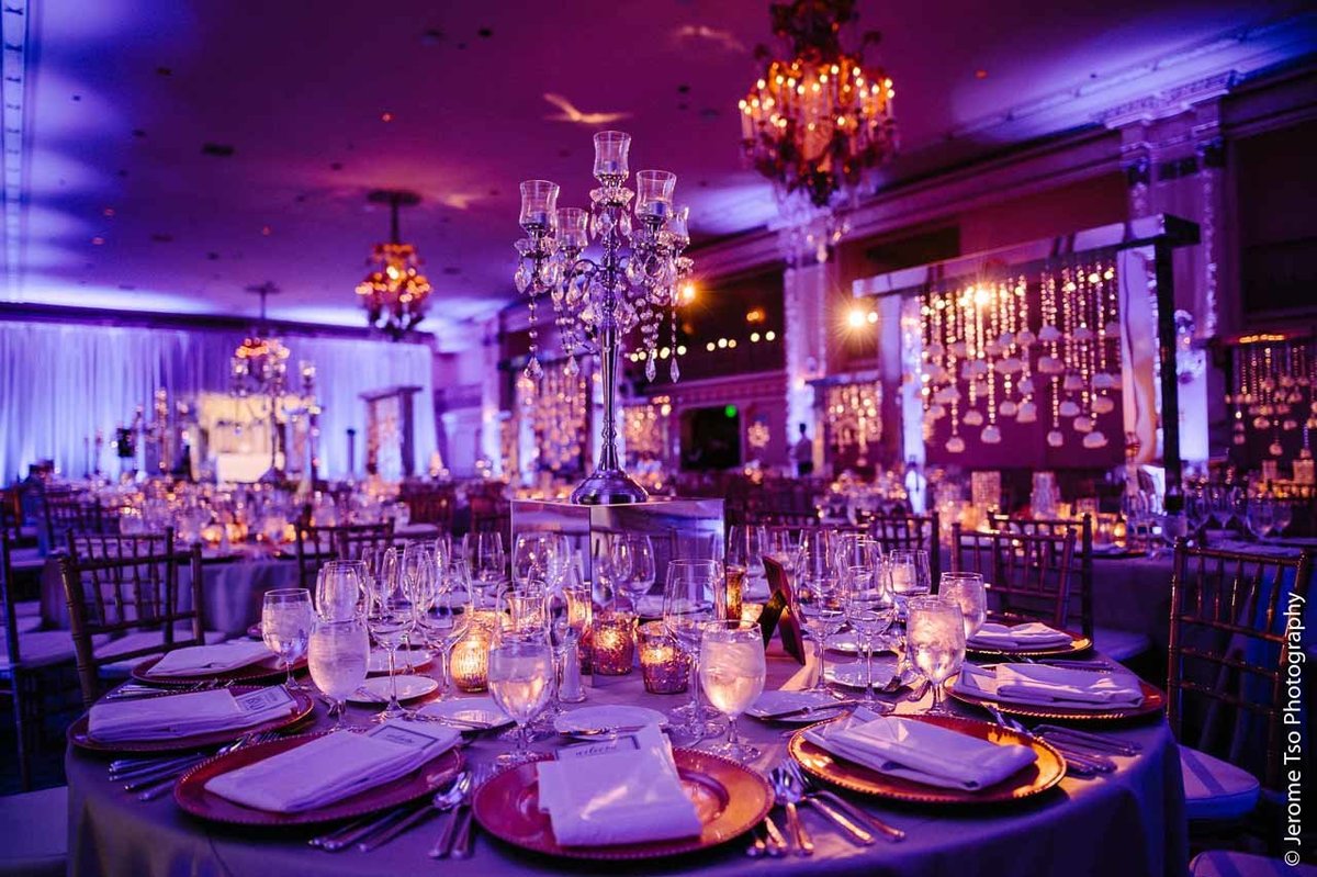 centerpiece of tall silver crystal candelabra on round reception table