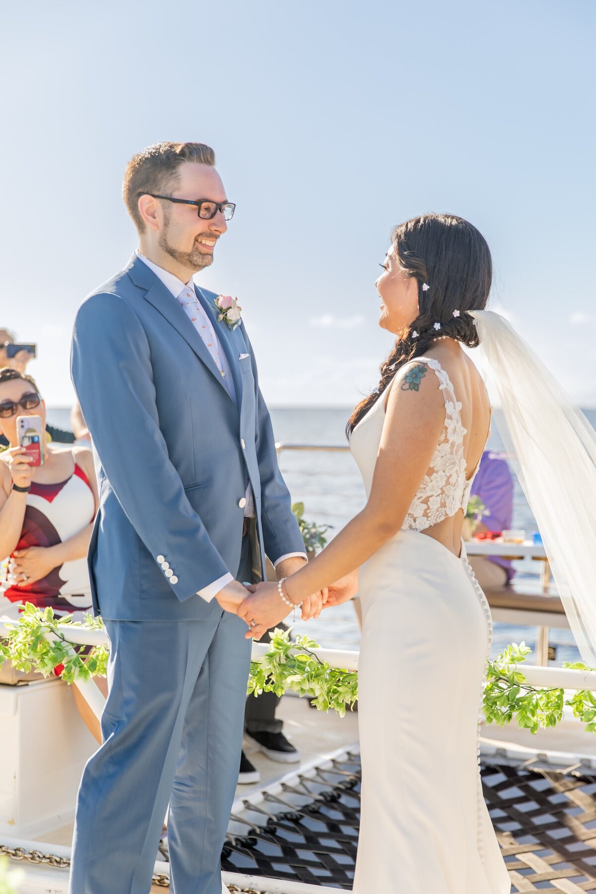 bride and groom holding hands during their wedding 