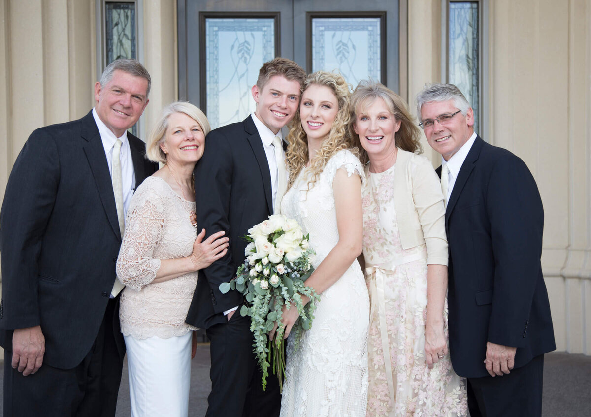 a wedding couple and both parents on their wedding day