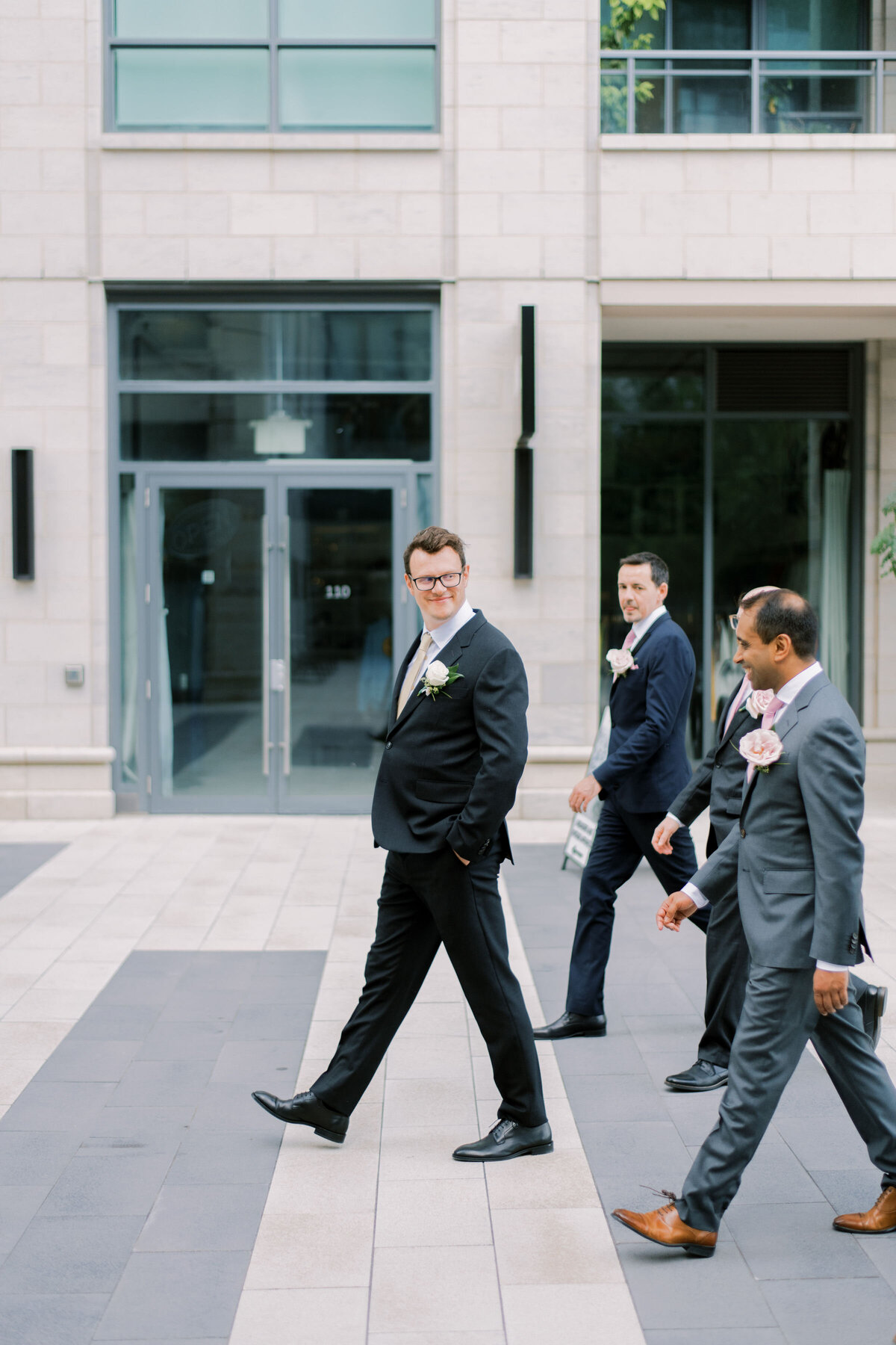 Groom wants with groomsman out on courtyard