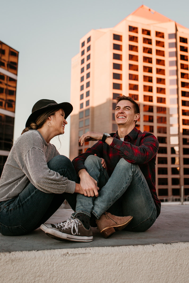 Couple sitting on a rooftop downtown Albuquerque