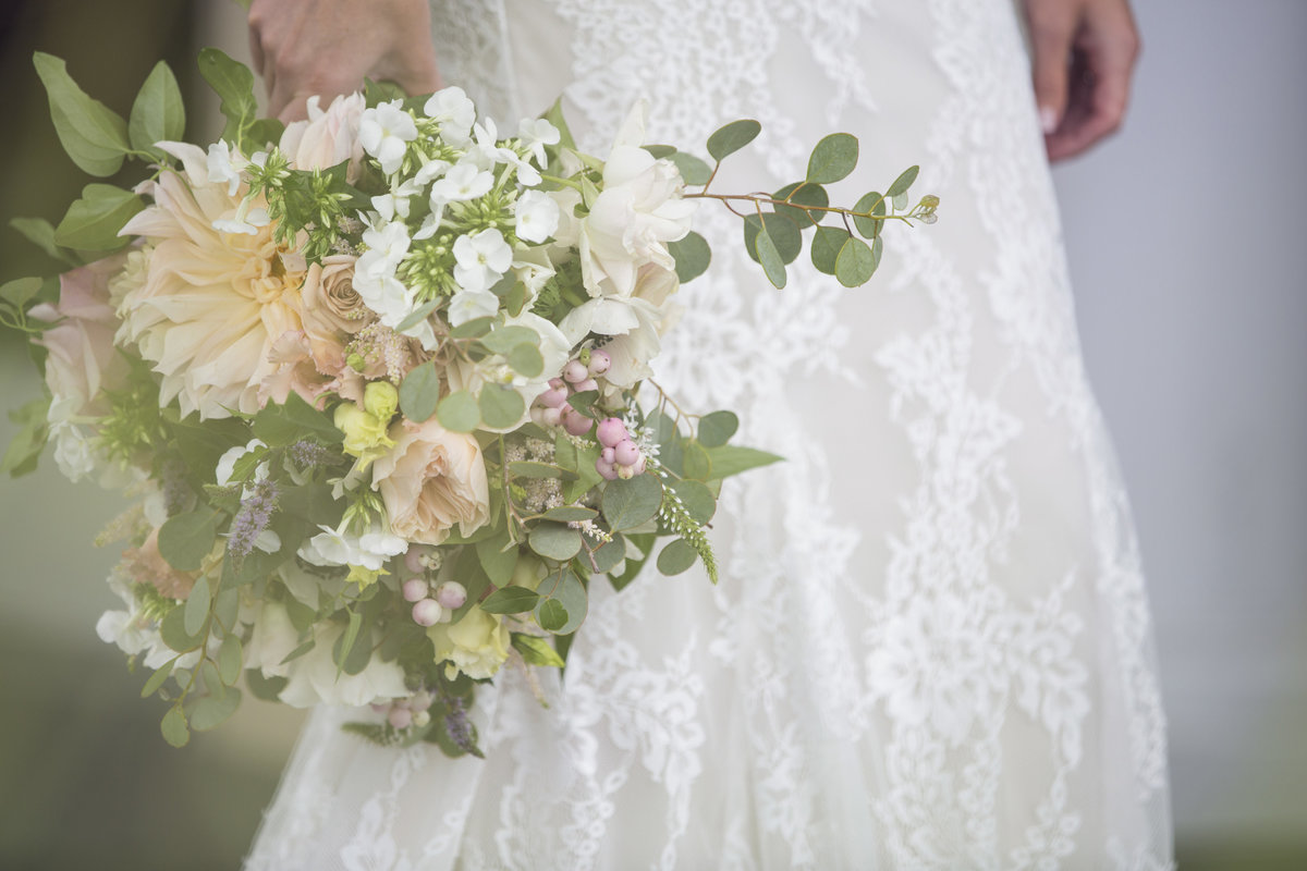 bride holding rustic organic flowers